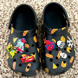 Toddler size 11 crocs, black with pizza , hotdog and hamburger design.